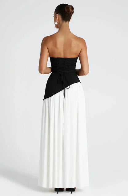 Un vestido sofisticado que combina el clásico blanco y negro con un diseño moderno y femenino. Perfecto para destacar con estilo en cualquier ocasión especial.